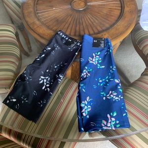 A set of Under Armor bike shorts .. one is navy the other is blue.